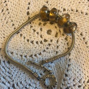 Four bronze colored charms. All stamped 925 fits Chamilia bracelets.